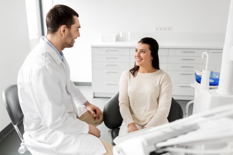 dentist explaining how to prevent dry socket to patient